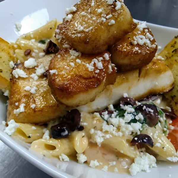 Yamas Bar & Grill's Greek pasta dish with scallops, feta, olives, and garlic bread.